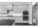 Well-equipped kitchen featuring stainless steel double ovens and ample storage space at 3380 Labrouste Cv, Duluth, GA 30097