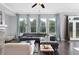Bright and airy living room features hardwood floors, large windows, and comfortable seating at 3380 Labrouste Cv, Duluth, GA 30097