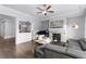 Open concept living room featuring stone fireplace, hardwood floors, and elegant décor at 3380 Labrouste Cv, Duluth, GA 30097