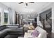 Spacious open-concept living room with hardwood floors, modern staircase and view to the kitchen at 3380 Labrouste Cv, Duluth, GA 30097