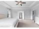 Spacious main bedroom features neutral tones, tray ceilings, and a ceiling fan at 3380 Labrouste Cv, Duluth, GA 30097