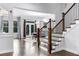 Elegant staircase with wooden banister and white risers, connecting living spaces at 3380 Labrouste Cv, Duluth, GA 30097