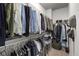Well-organized walk-in closet with hanging clothes and shelving at 3380 Labrouste Cv, Duluth, GA 30097