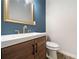 Stylish bathroom with modern fixtures, wood vanity, and blue accent wall at 962 Welch Sw St, Atlanta, GA 30310