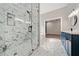 Modern bathroom with a glass-enclosed shower, double vanity, and sleek fixtures at 962 Welch Sw St, Atlanta, GA 30310