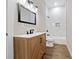 Modern bathroom with wood-grain vanity, white marble shower, and contemporary fixtures at 962 Welch Sw St, Atlanta, GA 30310