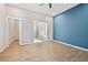 Bedroom featuring a stylish blue accent wall, natural light, and ensuite bathroom with modern finishes at 962 Welch Sw St, Atlanta, GA 30310