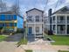 Charming two-story home features a balcony, blue door, and inviting front porch at 962 Welch Sw St, Atlanta, GA 30310