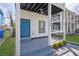 Charming covered porch features a turquoise door, gray concrete flooring, and a ceiling fan at 962 Welch Sw St, Atlanta, GA 30310