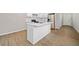 Modern kitchen featuring an island with a white countertop, stainless steel appliances, and light wood flooring at 962 Welch Sw St, Atlanta, GA 30310