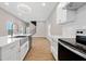 Modern kitchen featuring stainless steel appliances, white cabinets, and an island with a sink at 962 Welch Sw St, Atlanta, GA 30310