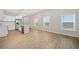 Bright living room with light wood floors, large windows, and an open kitchen area at 962 Welch Sw St, Atlanta, GA 30310