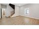 Bright living room with beautiful floors and staircase and window allowing for lots of natural light at 962 Welch Sw St, Atlanta, GA 30310