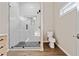 Modern shower with white subway tiles, frameless glass, and a pebble floor at 962 Welch Sw St, Atlanta, GA 30310