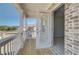 Balcony view, with a door to the bedroom, railing, and a glimpse of the neighborhood at 228 Chiswick Loop, Stockbridge, GA 30281