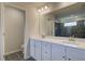 Bright bathroom featuring double sinks, quartz countertops, and modern fixtures at 228 Chiswick Loop, Stockbridge, GA 30281