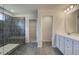 Modern bathroom featuring a tiled shower, double vanity with quartz countertops, and tile floors at 228 Chiswick Loop, Stockbridge, GA 30281