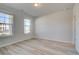 Bright and airy bedroom with large windows and neutral walls with laminate floors at 228 Chiswick Loop, Stockbridge, GA 30281