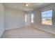 Bright bedroom with two windows, neutral carpet and light colored walls at 228 Chiswick Loop, Stockbridge, GA 30281