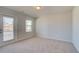 Bedroom with a private balcony and a large window for ample natural light at 228 Chiswick Loop, Stockbridge, GA 30281