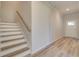 Inviting entryway with hardwood floors and staircase leading to upper level at 228 Chiswick Loop, Stockbridge, GA 30281