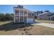 Charming two-story brick home with a double balcony and an attached two-car garage at 228 Chiswick Loop, Stockbridge, GA 30281