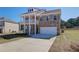 Charming two-story brick home with a double balcony and an attached two-car garage at 228 Chiswick Loop, Stockbridge, GA 30281