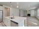 Kitchen island with stainless steel dishwasher offers an open-concept view to the living room with fireplace at 228 Chiswick Loop, Stockbridge, GA 30281