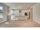 Bright kitchen features a center island, stainless steel appliances, and sleek white cabinetry at 228 Chiswick Loop, Stockbridge, GA 30281