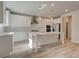This kitchen features stainless appliances, a large island with pendant lighting, and white cabinetry at 228 Chiswick Loop, Stockbridge, GA 30281
