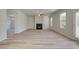 Living room with a fireplace, ceiling fan, and access to the backyard through a glass door at 228 Chiswick Loop, Stockbridge, GA 30281