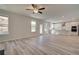 Spacious living room with open floor plan, hardwood floors, and bright kitchen at 228 Chiswick Loop, Stockbridge, GA 30281