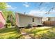 A level backyard features a classic ranch-style home with beige siding and a small rear entry deck at 286 Booker Sw St, Atlanta, GA 30315