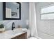 Stylish bathroom with tile shower, modern fixtures, and a decorative mirror at 286 Booker Sw St, Atlanta, GA 30315
