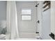 Well-lit bathroom with a white tile shower, black hardware, and stylish design at 286 Booker Sw St, Atlanta, GA 30315