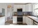 Modern kitchen featuring white cabinets, stainless steel appliances, and wood countertops with view to other rooms at 286 Booker Sw St, Atlanta, GA 30315