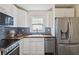 A well-lit kitchen featuring white cabinets, stainless steel appliances, and a window above the sink at 286 Booker Sw St, Atlanta, GA 30315