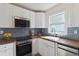 Modern kitchen featuring white cabinets, stainless steel appliances, and wood countertops at 286 Booker Sw St, Atlanta, GA 30315