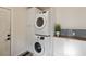 Convenient laundry area with stacked washer and dryer, and additional storage cabinets at 286 Booker Sw St, Atlanta, GA 30315