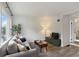 Bright living room with wood floors, a comfortable couch, and a large window at 286 Booker Sw St, Atlanta, GA 30315