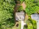 Aerial view of a house with a well-maintained lawn, patio, and lush landscaping at 4910 Conover Dr, Atlanta, GA 30338