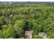 Aerial view of a home with mature trees, lush green landscaping, and surrounding neighborhood at 4910 Conover Dr, Atlanta, GA 30338