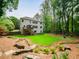 Spacious backyard featuring a multi-level deck, fire pit, and mature trees, offering privacy at 4910 Conover Dr, Atlanta, GA 30338