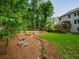 Beautifully landscaped backyard with a rock-lined stream and wooden deck with outdoor seating at 4910 Conover Dr, Atlanta, GA 30338