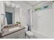 Bathroom featuring granite countertops, a tub with shower, and white subway tile at 4910 Conover Dr, Atlanta, GA 30338