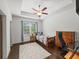 Cozy bedroom with a tray ceiling, large window, and a wooden bed frame at 4910 Conover Dr, Atlanta, GA 30338