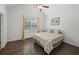 Bright bedroom with a vaulted ceiling, window, and yellow patterned bedspread at 4910 Conover Dr, Atlanta, GA 30338