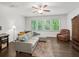 Bonus room with large windows, a ceiling fan, and a comfortable couch with throw pillows at 4910 Conover Dr, Atlanta, GA 30338