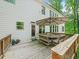 Exterior view of the wooden deck featuring wooden railings and an umbrella-covered dining set and white siding at 4910 Conover Dr, Atlanta, GA 30338