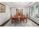Traditional dining room boasts wainscoting, wood table, and large window for natural light at 4910 Conover Dr, Atlanta, GA 30338